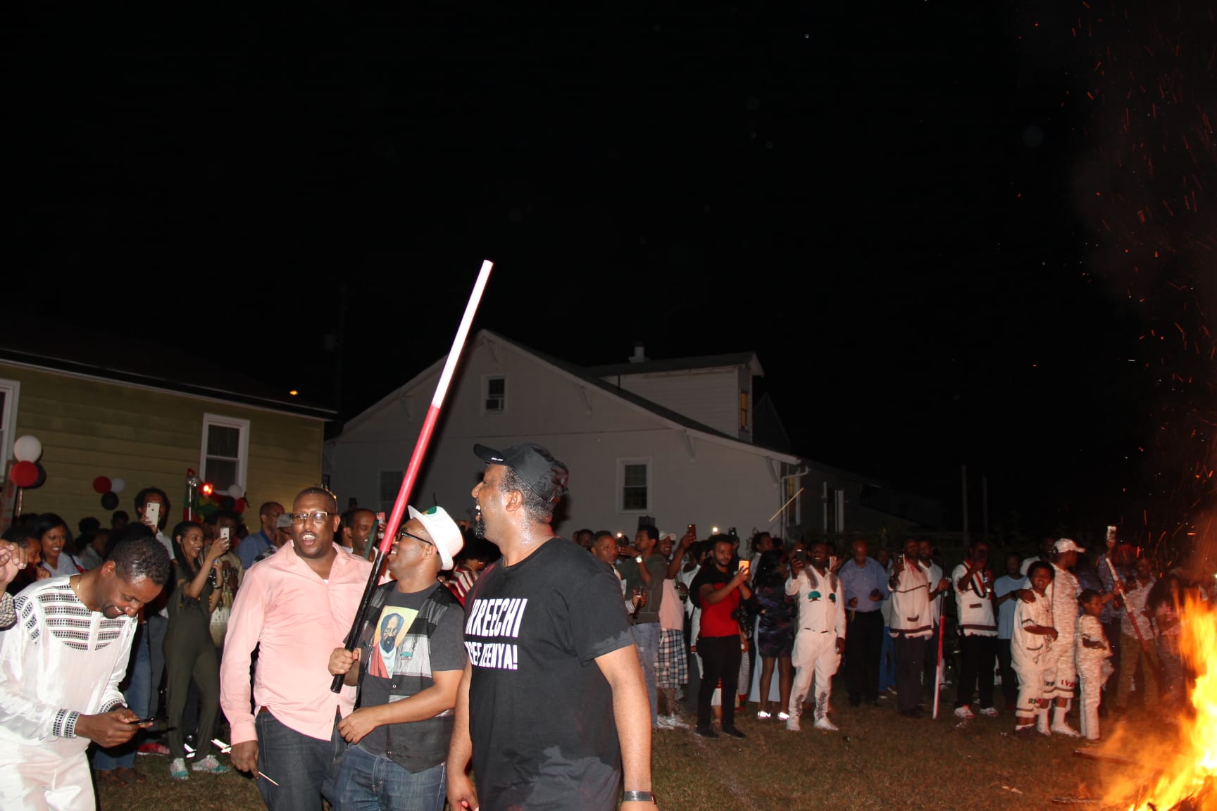 Oromo families in traditional white and colorful clothing at festival gathering